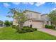 Charming two-story home with a two-car garage, manicured lawn, and lush landscaping at 1354 Riley Cir, Deland, FL 32724