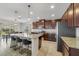 Kitchen with stainless steel appliances, dark wood cabinetry, granite countertops, and a kitchen island with barstool seating at 1354 Riley Cir, Deland, FL 32724