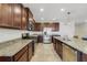 Spacious kitchen with stainless steel appliances, dark wood cabinetry, and granite countertops, ideal for cooking at 1354 Riley Cir, Deland, FL 32724