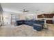 Open-concept living room featuring tile floors, a large sectional sofa, and seamless integration with the kitchen and dining area at 1354 Riley Cir, Deland, FL 32724