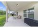 Covered patio with grill, comfortable seating, and storage at 1354 Riley Cir, Deland, FL 32724
