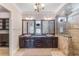 Elegant bathroom with double sink vanity, granite counters, decorative mirrors and tiled walk-in shower at 13798 Walcott Ave, Orlando, FL 32827