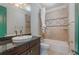 Well-lit bathroom featuring a shower-tub combo, decorated tile accent, and a sleek vanity at 13798 Walcott Ave, Orlando, FL 32827
