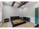 Bedroom featuring decorative ceiling beams, neutral carpeting, and green-painted door at 13798 Walcott Ave, Orlando, FL 32827