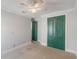 Bedroom with plush carpeting and green painted double door access to other rooms at 13798 Walcott Ave, Orlando, FL 32827