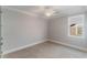 Bright bedroom featuring neutral carpet, white trim, and a modern ceiling fan with an integrated light at 13798 Walcott Ave, Orlando, FL 32827