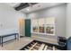 Bedroom featuring decorative ceiling beams, neutral carpeting, and green-painted door at 13798 Walcott Ave, Orlando, FL 32827