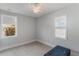 Bedroom with a ceiling fan, neutral paint, and two windows at 13798 Walcott Ave, Orlando, FL 32827