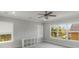 Bright bedroom with large windows, neutral carpet, and a modern ceiling fan at 13798 Walcott Ave, Orlando, FL 32827