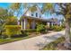 Beautiful exterior view of a two-story home with vibrant landscaping and a welcoming front porch at 13798 Walcott Ave, Orlando, FL 32827