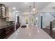 Bright kitchen featuring a large island, modern lighting, and stainless steel appliances at 13798 Walcott Ave, Orlando, FL 32827
