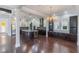 Open-concept kitchen with large island, custom cabinetry, stainless steel appliances, and hardwood floors at 13798 Walcott Ave, Orlando, FL 32827