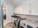 Convenient laundry room features modern washer, dryer and ample storage in the cabinets at 13798 Walcott Ave, Orlando, FL 32827