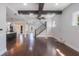 Open-concept living room with wood floors, ceiling beams, and staircase at 13798 Walcott Ave, Orlando, FL 32827