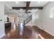Bright living room with hardwood floors, beamed ceilings, and staircase access at 13798 Walcott Ave, Orlando, FL 32827