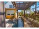 Charming back patio with water feature, covered by a pergola for shade, blending indoor/outdoor living at 13798 Walcott Ave, Orlando, FL 32827