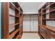 Spacious walk-in closet with custom wood shelving and drawers to keep items organized at 13798 Walcott Ave, Orlando, FL 32827