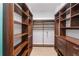 Spacious walk-in closet with custom wood shelving and drawers to keep items organized at 13798 Walcott Ave, Orlando, FL 32827