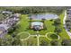 Aerial view showcasing the community pool, lake, and surrounding lush greenery at 14521 Tanja King Blvd, Orlando, FL 32828