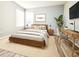 Bedroom with minimalist decor, light colors, a tv, and updated desk at 14521 Tanja King Blvd, Orlando, FL 32828