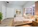 Cozy bedroom featuring floral accents, warm lighting, and a comfortable bed at 14521 Tanja King Blvd, Orlando, FL 32828