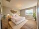 Cozy bedroom with a chandelier, a neutral rug and decorative wall hangings at 14521 Tanja King Blvd, Orlando, FL 32828
