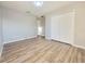 Bedroom featuring wood-look floors, white walls, and a double door closet at 14521 Tanja King Blvd, Orlando, FL 32828