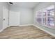 Simple bedroom with wood-look floors and lots of light at 14521 Tanja King Blvd, Orlando, FL 32828