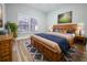 Bright bedroom featuring a large window, wood furniture, and hardwood floors at 14521 Tanja King Blvd, Orlando, FL 32828