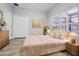 Bedroom with neutral tones, wood-look floors, and a view from the window at 14521 Tanja King Blvd, Orlando, FL 32828