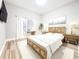 Staged bedroom with hardwood floors, natural light, and a desk at 14521 Tanja King Blvd, Orlando, FL 32828