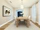 Bright dining room with a wooden table, modern chandelier, and neutral decor at 14521 Tanja King Blvd, Orlando, FL 32828