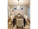 Dining room featuring a modern light fixture, neutral paint, and stylish decor at 14521 Tanja King Blvd, Orlando, FL 32828