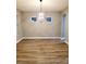 Dining room featuring a modern light fixture, neutral paint, and wood floors at 14521 Tanja King Blvd, Orlando, FL 32828