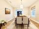 Bright dining room with a large table, wood floors, and a modern light fixture at 14521 Tanja King Blvd, Orlando, FL 32828