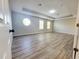 Neutral room with tray ceilings, round window, modern flooring, and bright light from multiple windows at 14521 Tanja King Blvd, Orlando, FL 32828
