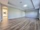 Spacious empty room with light gray walls and wood-look vinyl flooring at 14521 Tanja King Blvd, Orlando, FL 32828
