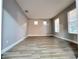 Spacious room with light gray walls, modern light-colored floors, and bright natural light from multiple windows at 14521 Tanja King Blvd, Orlando, FL 32828