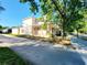 Side view of a two-story home with large porch, nice landscaping and proximity to street at 14521 Tanja King Blvd, Orlando, FL 32828