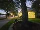 Beautiful property with sidewalk featuring elegant yard decor and manicured lawn at dusk at 14521 Tanja King Blvd, Orlando, FL 32828
