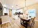 Bright eat-in kitchen with center island, modern light fixture, and updated cabinets at 14521 Tanja King Blvd, Orlando, FL 32828