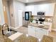 A kitchen featuring white cabinets, stainless steel appliances, and an island with granite countertops at 14521 Tanja King Blvd, Orlando, FL 32828