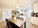 Eat-in kitchen featuring a center island, and view into adjacent living area and patio door at 14521 Tanja King Blvd, Orlando, FL 32828