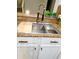 Close-up of kitchen sink with modern faucet, cutting board and dish rack at 14521 Tanja King Blvd, Orlando, FL 32828