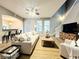 Bright living room featuring a sectional sofa, ceiling fan, and staircase at 14521 Tanja King Blvd, Orlando, FL 32828