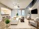 Living room features a sectional sofa, modern decor, and a staircase at 14521 Tanja King Blvd, Orlando, FL 32828