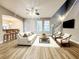 Cozy living room features a ceiling fan, comfortable seating, and a staircase at 14521 Tanja King Blvd, Orlando, FL 32828