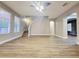 Open living room featuring wood floors, neutral paint, a staircase, and abundant natural light at 14521 Tanja King Blvd, Orlando, FL 32828