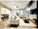 Open-concept living room with a ceiling fan, hardwood floors, and staircase at 14521 Tanja King Blvd, Orlando, FL 32828