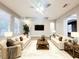 Bright living room showcasing modern decor, plush seating, and a statement ceiling fan at 14521 Tanja King Blvd, Orlando, FL 32828